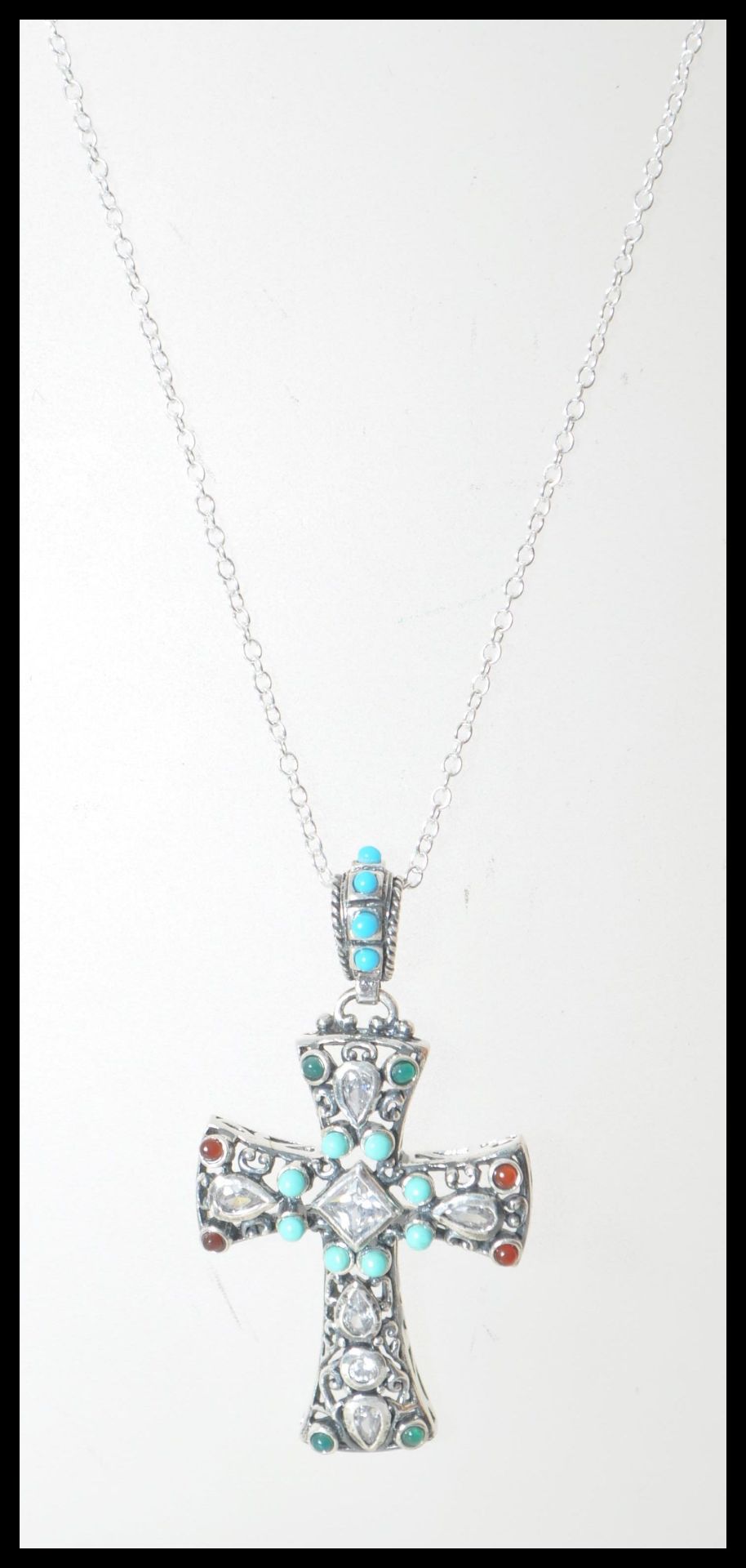 A stamped 925 silver necklace having a crucifix pendant set with turquoise cabochons  and white