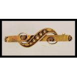 A 14ct gold 19th Century Victorian bar brooch having scrolled decoration to the front. tests as 14ct