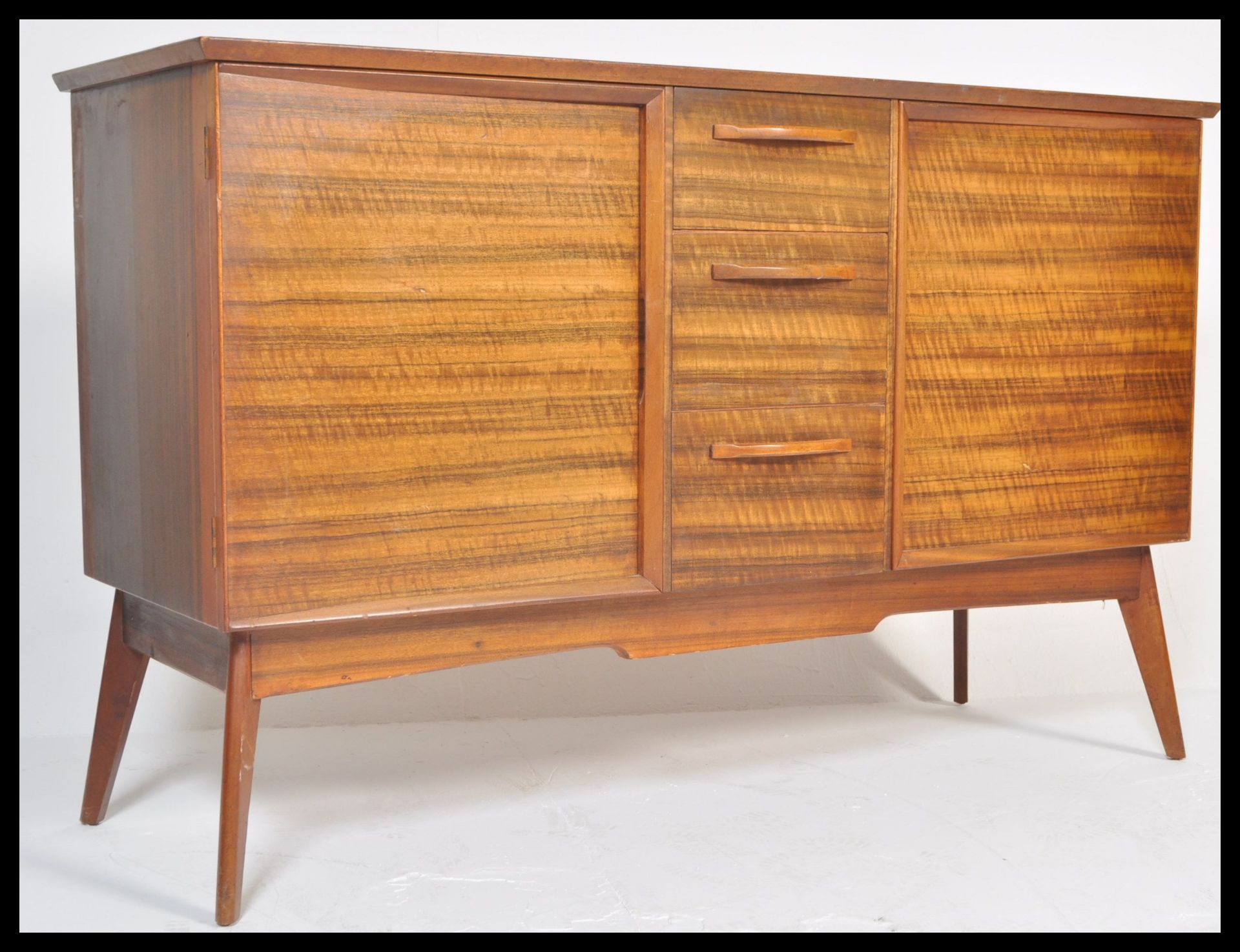 Alfred Cox - A  vintage 20th century oak sideboard credenza having a central bank of 3 drawers