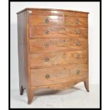 An early 19th Century Georgian mahogany bow front attic chest of drawers having inlay decorated top.
