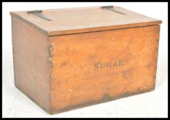 A vintage early 20th Century antique large wooden sugar storage box having a hinged lid with