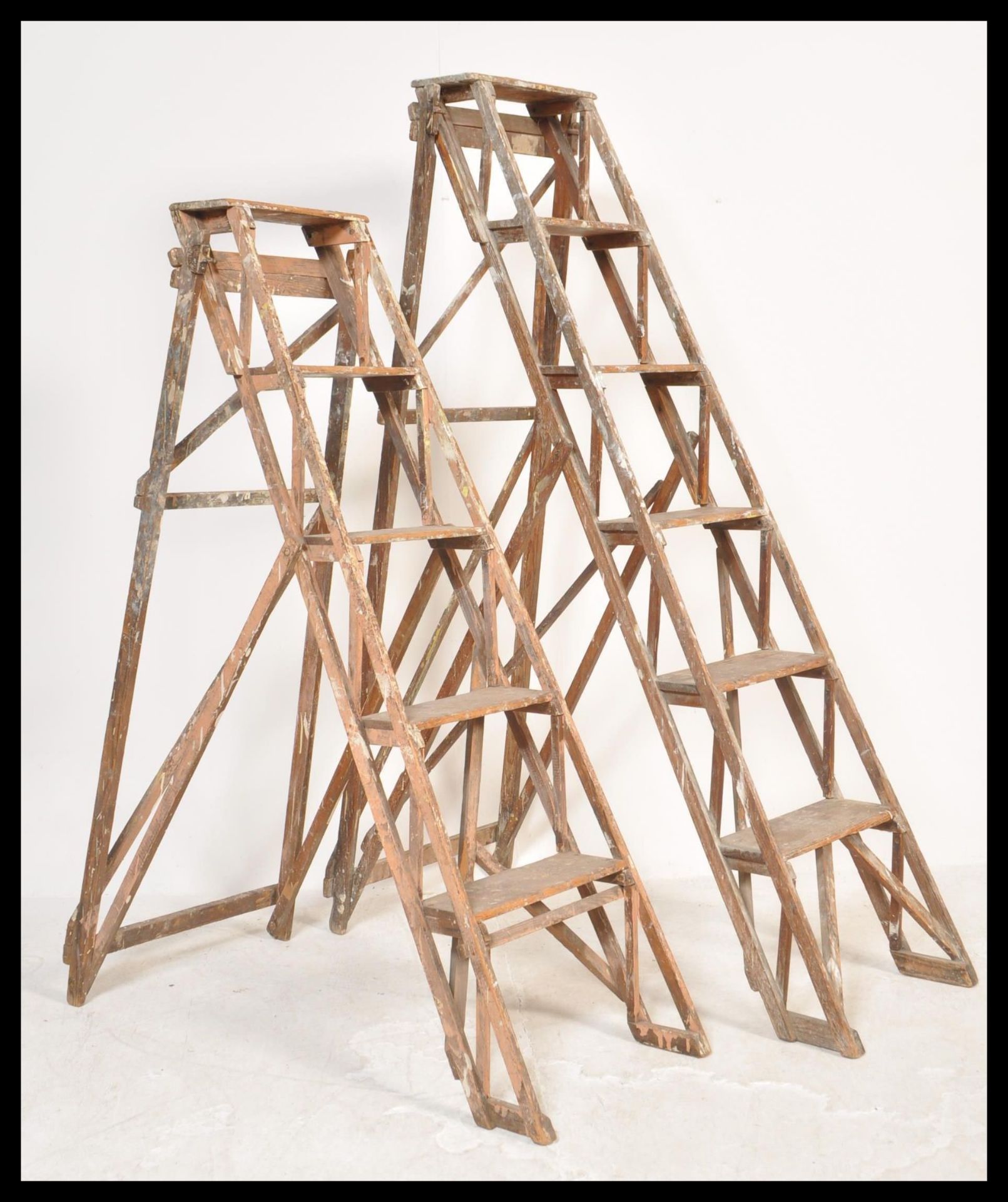 Two good early 20th century Industrial wooden trestle ladder. Each with A-frame design having