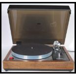 A Linn Sondek LP12 Transcription turntable, the teak cased surround having a smoked perspex hinged