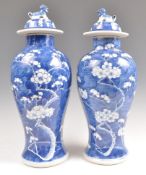 A PAIR OF 19TH CENTURY CHINESE PRUNUS PATTERN VASES AND COVERS