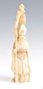 A 19TH CENTURY CHINESE IVORY FIGURINE OF AN ELDER BEING SIGNED,