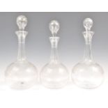 A SET OF THREE 19TH CENTURY GLASS DECANTERS AND STOPPERS