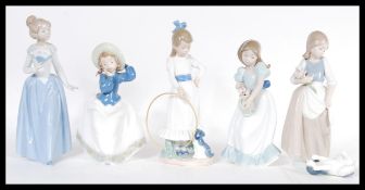 A collection of five Nao porcelain figurines to in