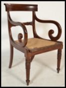 A 19th Century mahogany carver dining chair of Trafalgar type raised on reeded legs with shaped