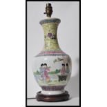 A 20h Century Chinese vase table lamp raised on socle wooden base having white cartouche body