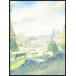 A 20th Century watercolour painting on paper depicting the view across a graveyard with a town