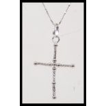 A stamped 750 white gold necklace having a crucifix pendant on a fine twisted chain. Chain