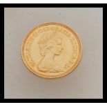 A 1982 half gold sovereign with Queen Elizabeth facing right. Weight 4.0g.