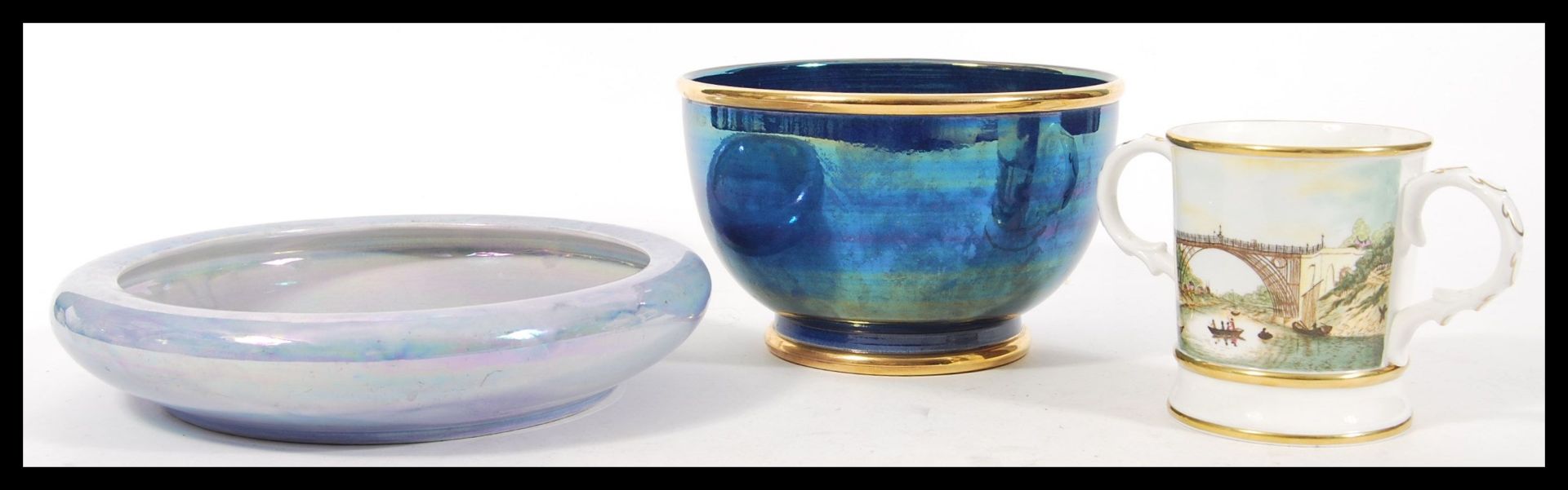 A 20th century Devon Lustre Fieldings centrepiece bowl with lilac colouration along with a dark blue