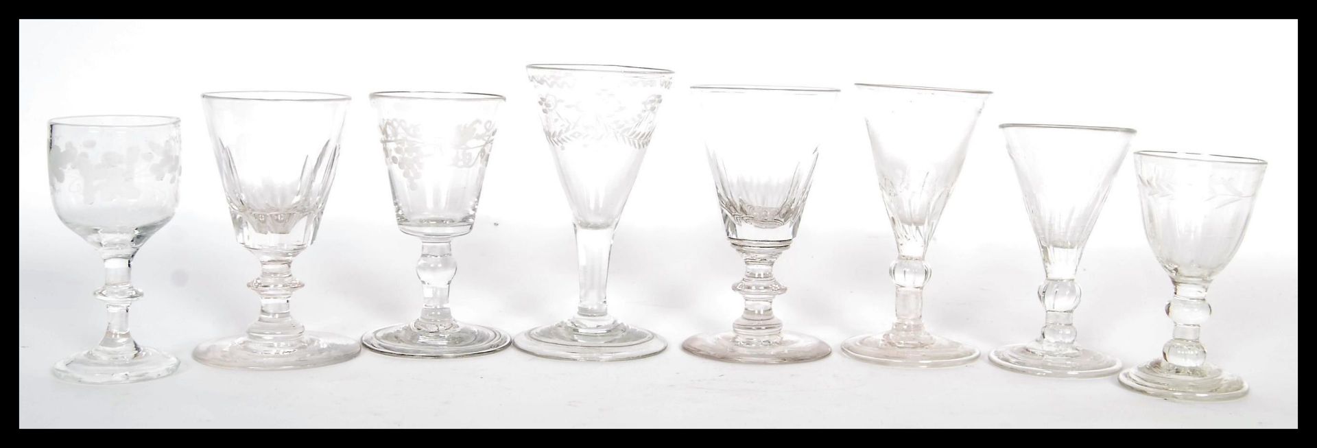 A group of eight 18th / 19th Century Georgian glass drinking glasses to include faceted and etched