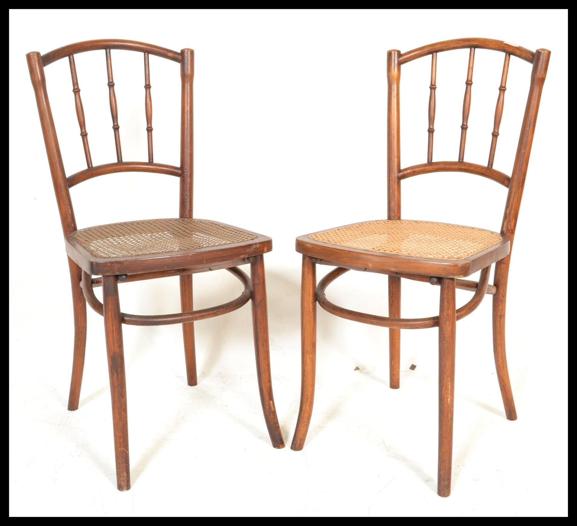A pair of early 20th Century bentwood bedroom chairs in the manner of Thonet having bergere seats.