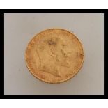 A 1909 Edward VII London mint full gold sovereign. Weight 8.0g.