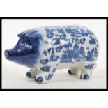 A vintage 20th Century large ceramic money bank box in the form of a pig having blue and white
