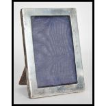 An early 20th Century hallmarked silver easel back photograph frame of rectangular form bearing