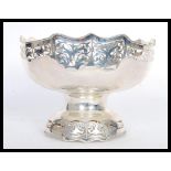 A large and impressive silver white metal table centerpiece bowl raised on pedestal base with fret