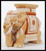 A decorative 20th Century stone / ceramic garden seat in the form of an elephant, decorated in