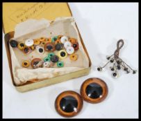 A collection of vintage antique glass eyes for dolls or bears of varying form and sizes.
