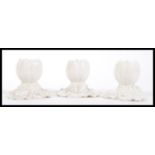 A set of three 19th Century Victorian Royal Worcester blanc de chine bud vases in the form of