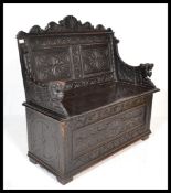 A 19th Century Victorian oak settle monks bench in the 17th Century style having large carved lion