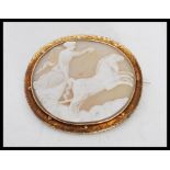 A 19th Century Victorian cameo brooch having a carved conch shell panel depicting the Goddess set