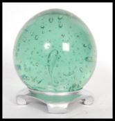 A large 19th Century Victorian Nailsea green glass paperweight dumb of bulbous form having large