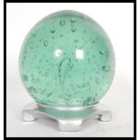 A large 19th Century Victorian Nailsea green glass paperweight dumb of bulbous form having large