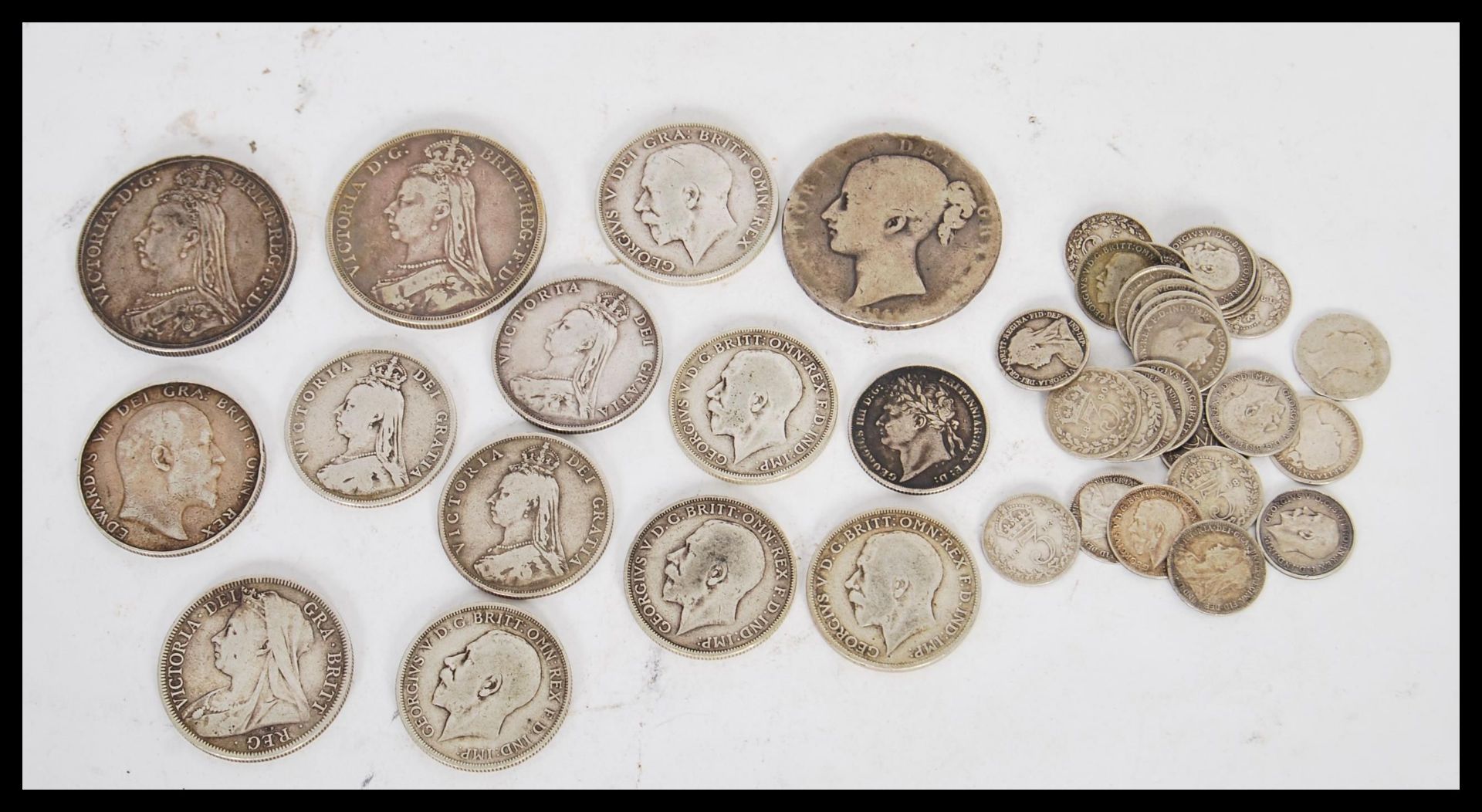 A selection of silver coins mostly dating from the Victorian era to include an 1899 half crown, a