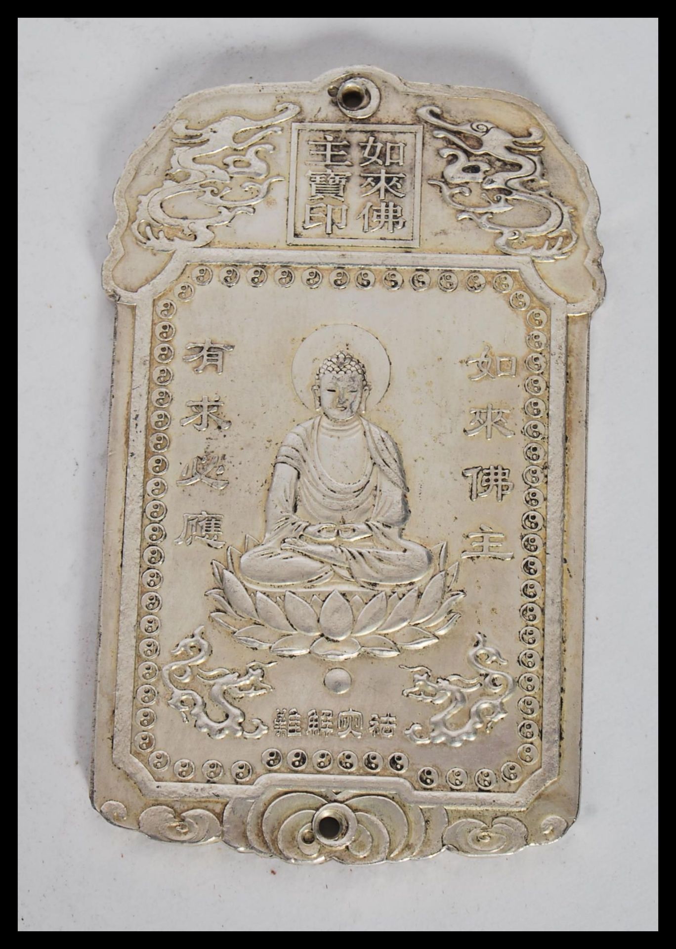 A 20th Century Chinese silver white metal ingot panel pendant of shaped rectangular form depicting
