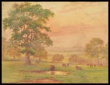 A 19th Century watercolour painting depicting highland cattle and landscape set to an ornate gilt