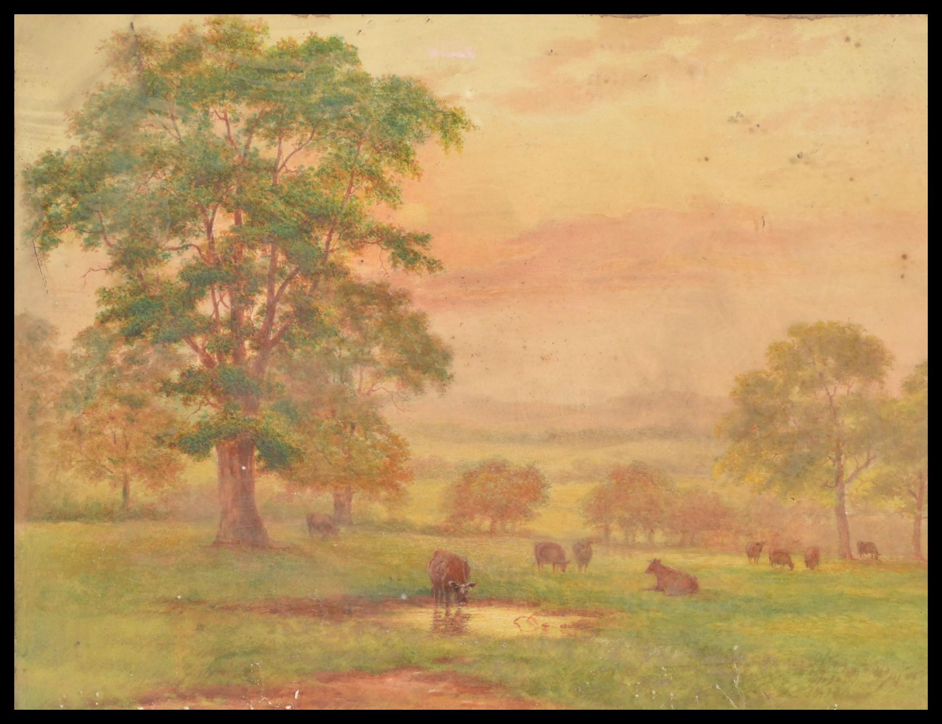 A 19th Century watercolour painting depicting highland cattle and landscape set to an ornate gilt