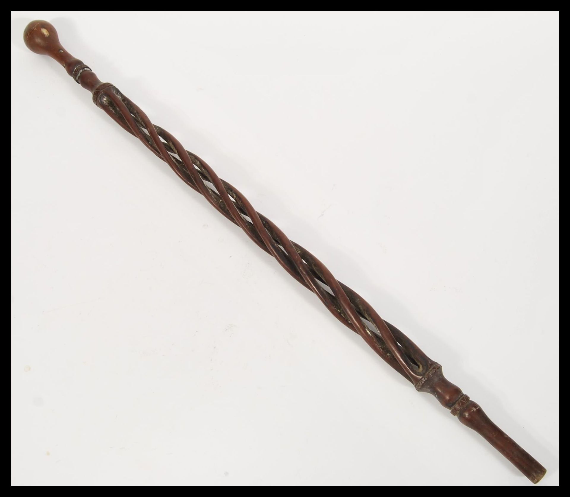 A 19th Century Victorian folk art walking stick cane having a carved twist open column with knob