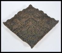 An antique 19th century Victorian printers wood block, heavily carved applied brass to form an