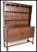 An early 20th Century 1920's oak dresser raised on block and turned legs with two drawers over two