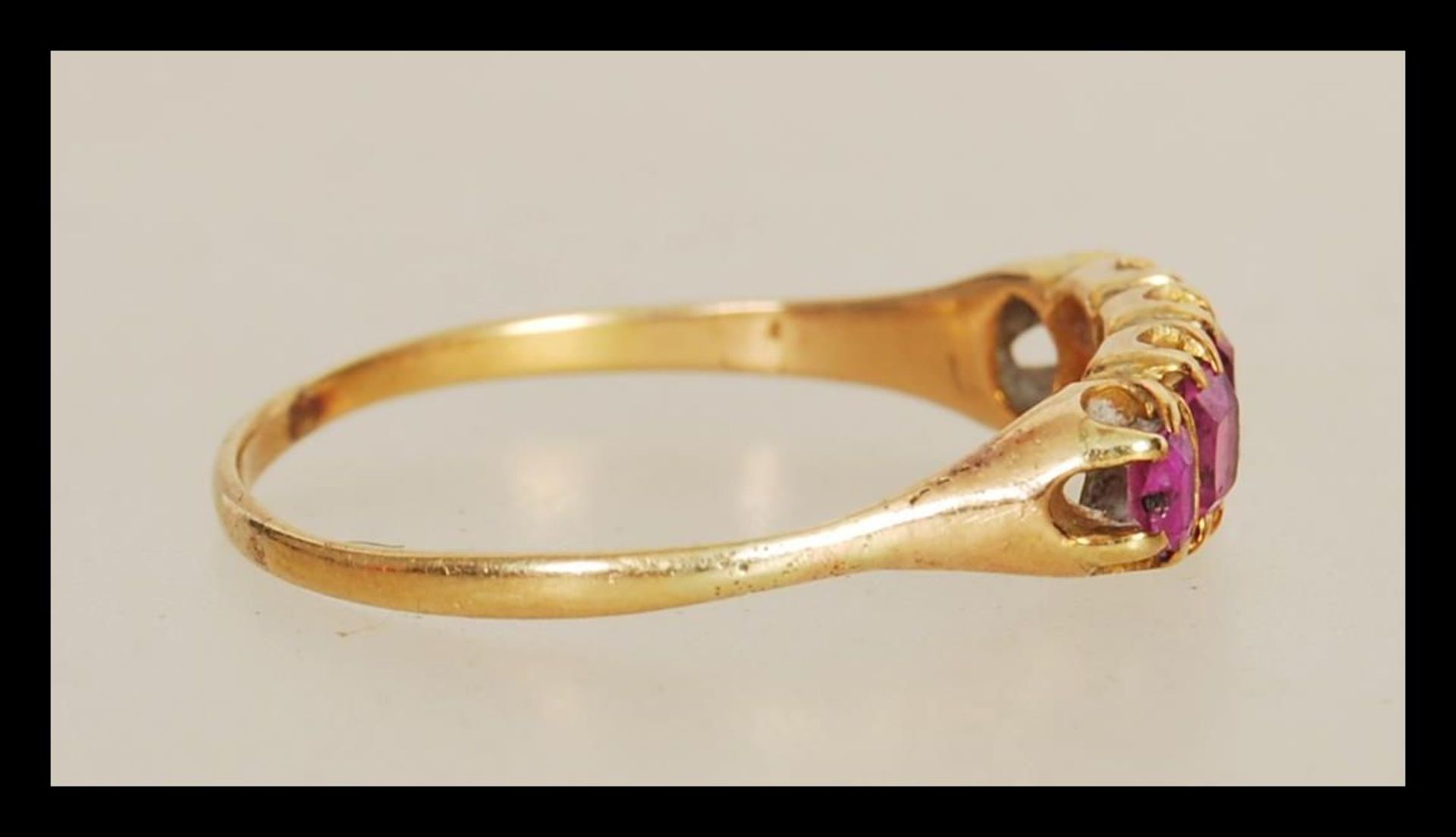 An early 20th Century 18ct gold ring prong set with five rectangular cut pink stones. Unmarked but - Image 2 of 3