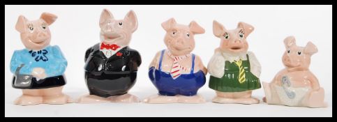 A group of five vintage advertising Natwest ' piggies ' ceramic money boxes in the form of pigs to