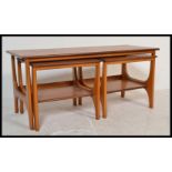 A vintage retro 20th Century teak wood occasional coffee nest of tables consisting of a taller