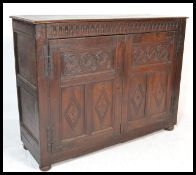 An 18th / 19th century carved oak Jacobean revival livery cupboard of large form. The wide and