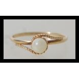 A 9ct 375 gold pearl solitaire ring having a 1.5mm half round shank with rope twist wire shoulders