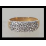 A hallmarked 9ct gold ring having three rows of white stones in white gold setting. Weighs 3.4