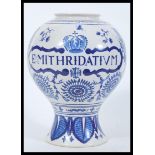 A large 18th Century Dutch style apothecary tin glazed earthenware jar having hand painted blue