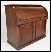 A Victorian 19th century mahogany cylinder roll top bureau. Raised on a plinth base having a