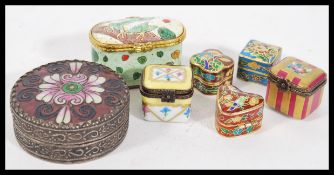 A collection of 20th Century pill boxes to include a Limoges ceramic pill box having hand painted