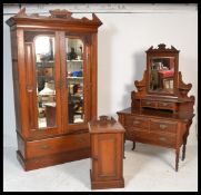 An Edwardian walnut 3 piece bedroom suite comprising a single wardrobe with plinth drawer base and