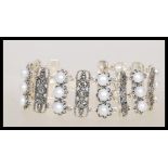 An Art Deco style panel bracelet having alternating panels set with pearls and marcasites.