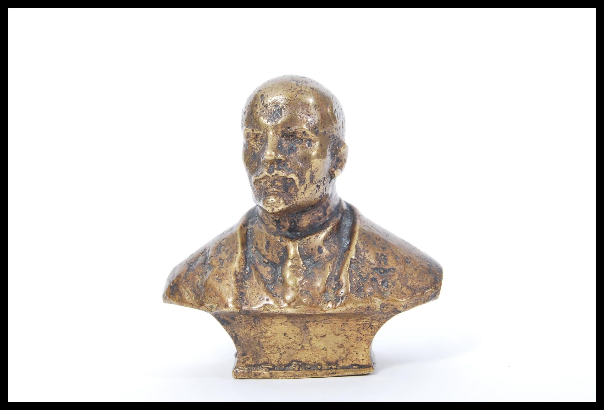 A 20th Century Russian cast bronze table top bust of Lenin raised on a square base, signed illegibly