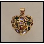 A stamped 750 gold pendant in the shape of a heart set with multi cut coloured stones. Weight 5.